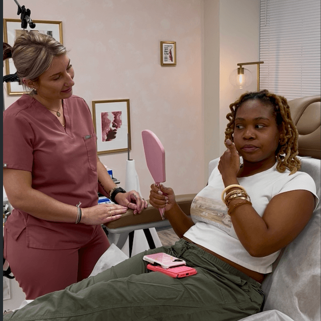 Girl holding up her left arm up exposing her smooth underarm after getting laser hair removal.