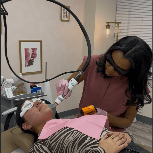 Female lifting both of her arms up after getting laser hair removal.