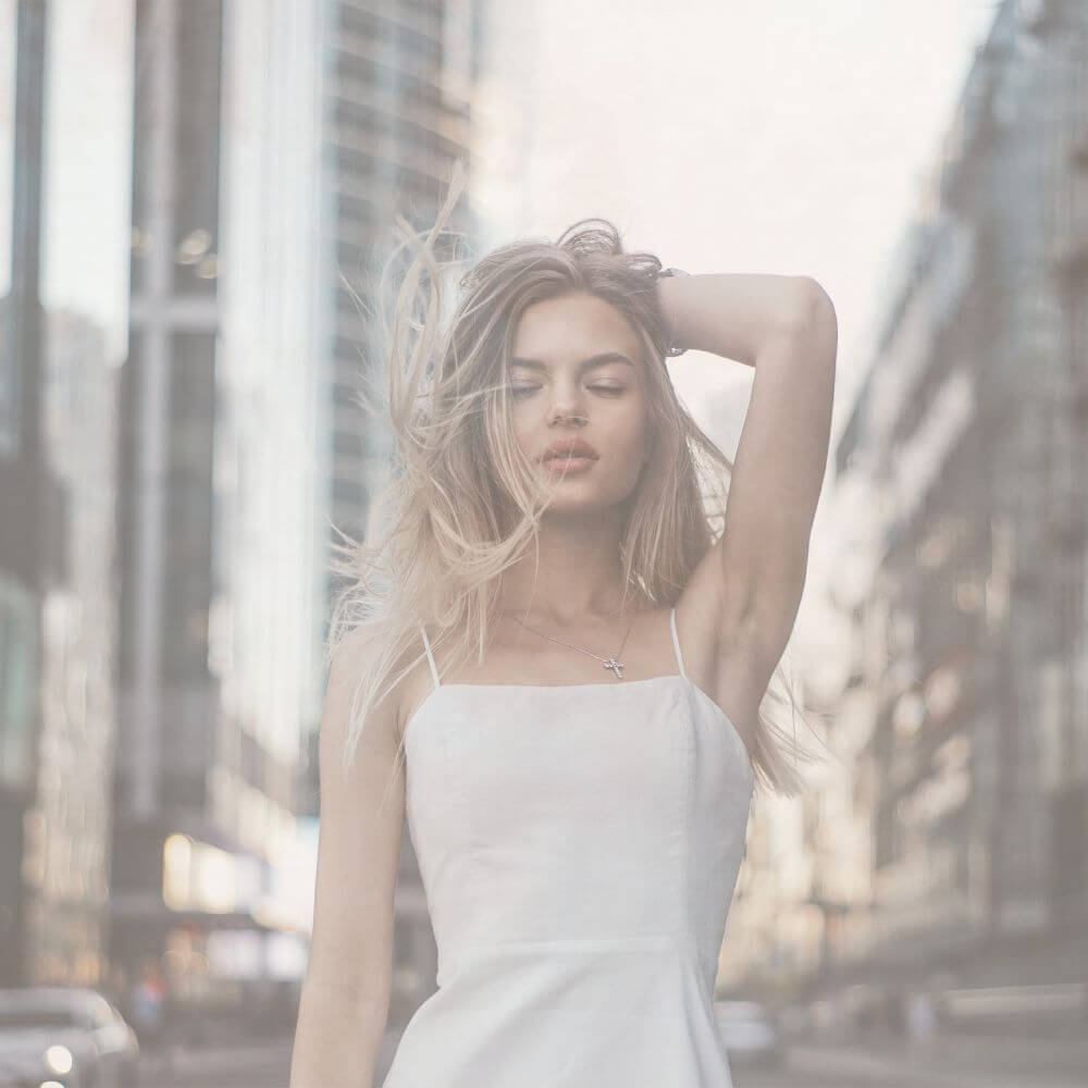 Girl holding up her left arm up exposing her smooth underarm after getting laser hair removal.